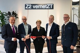 The picture shows five people standing in front of a light installation