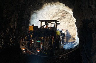 Photo shows an excavator at work in a tunnel tube