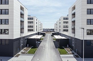 Visualisierung vom IN-Campus mit vier symmetrisch angeordnete Gebäudemodule in U-Form, mit Blick zwischen den Gebäuden. 