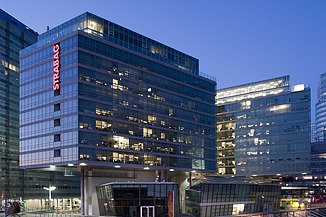 The illuminated STRABAG office can be seen at dusk in Vienna. 